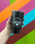 Black tumbler with 'Java Love' logo held against a colorful geometric background
